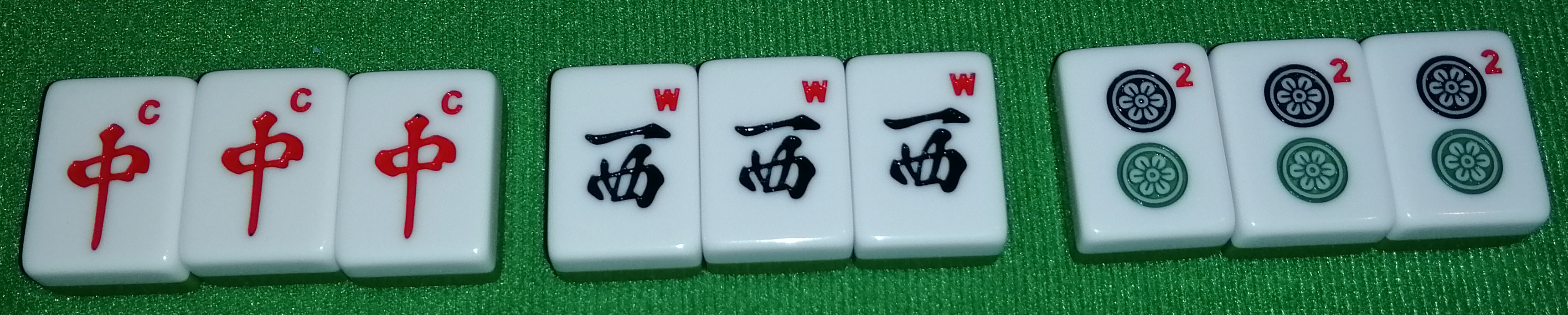 Three different triple melds, from left to right: A Chun triple, a Sha triple, and a 2-Pin triple.